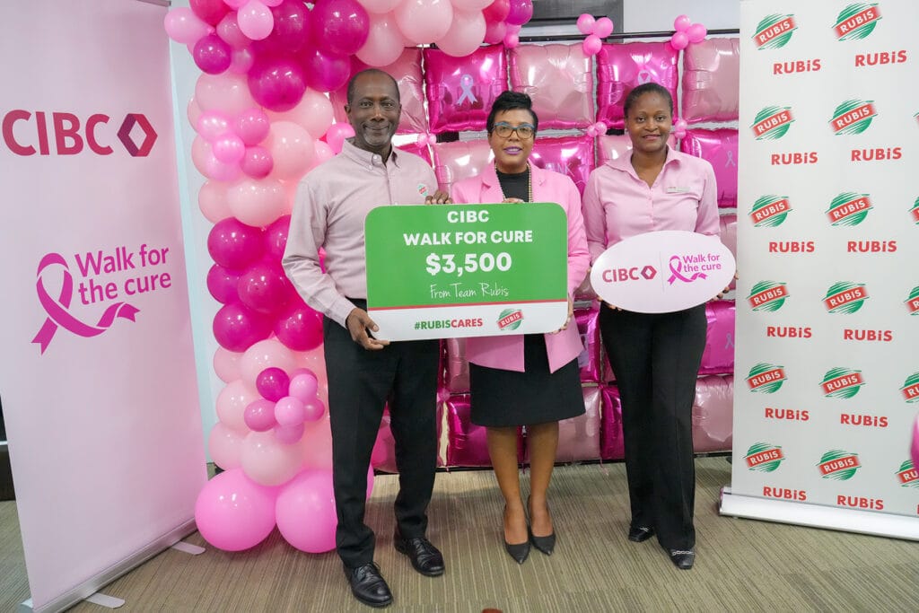 Curtis Francis, Accounts Executive, RUBIS, presenting the gold sponsorship to Ladesa James-Williams, Country Head of CIBC Caribbean Antigua, and Natasha Charles, CIBC’s Director of Retail Sales OECS and Walk Manager for Antigua.