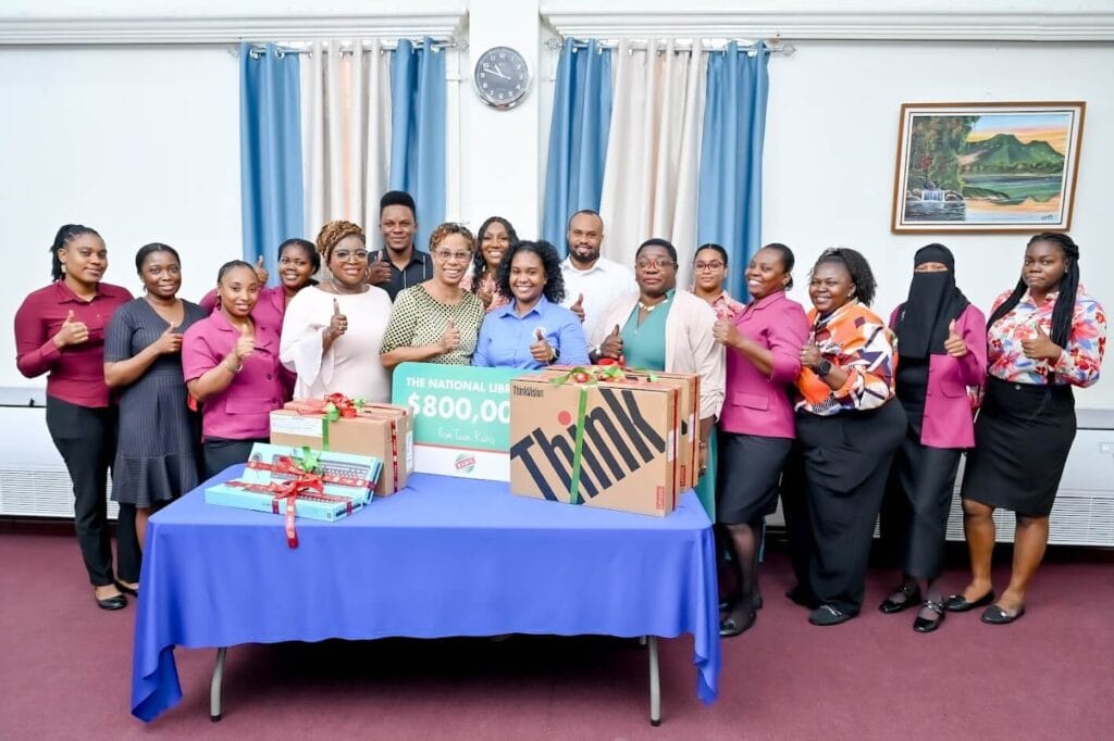 Natasha Brown, Sales & Marketing Coordinator, RUBIS (centre) and Emiley King, Chief Librarian (centre right) at the presentation with team members from the National Library.