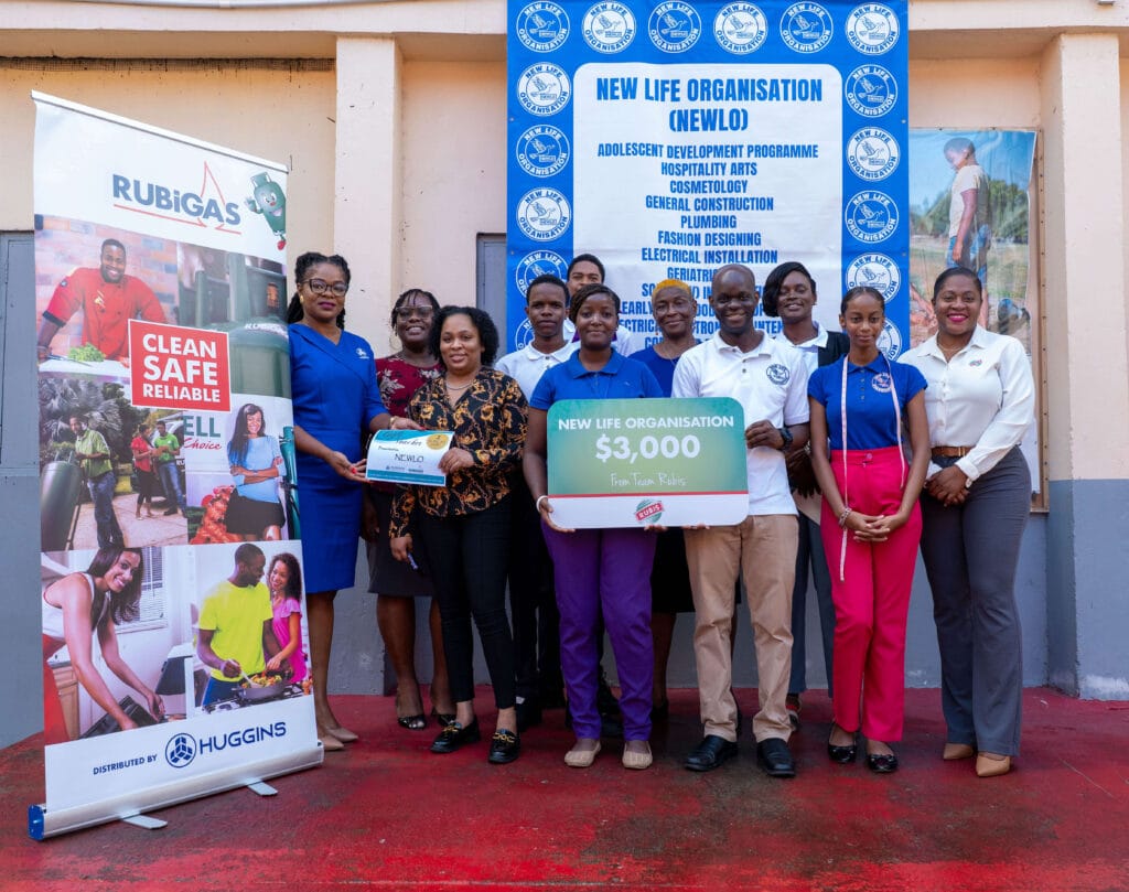 Students from the NEWLO Culinary and Fashion Departments gather for the presentation, as Huggins Petroleum representative Mrs. Kizzy Bartholomew (left) presents to RUBIS Sales & Marketing Coordinator Ms. Catoria Jeremiah, accompanied by RUBIS Accounts Executive Areen Lewis (right), and Marketing & Job Placement Manager Ms. Dale Neptune (third from right).