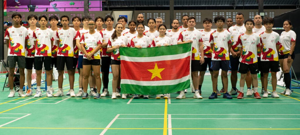 The Suriname National Badminton team, in their striking national kit, proudly sponsored by RUBIS.